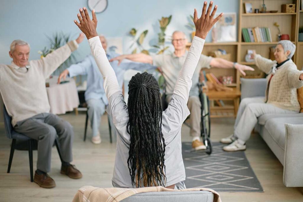 A senior resident arranging personal items in a cozy, well-lit living space.
