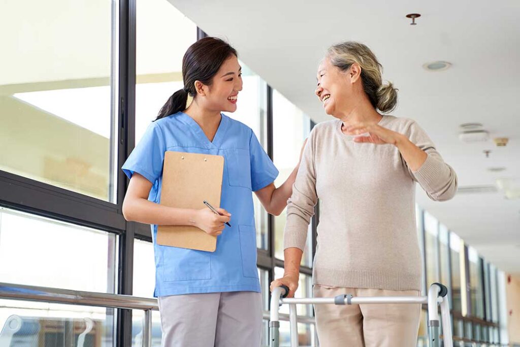 Older adult and family member reviewing care options with a staff member in a bright residential lounge