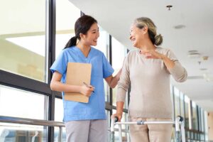 Older adult and family member reviewing care options with a staff member in a bright residential lounge